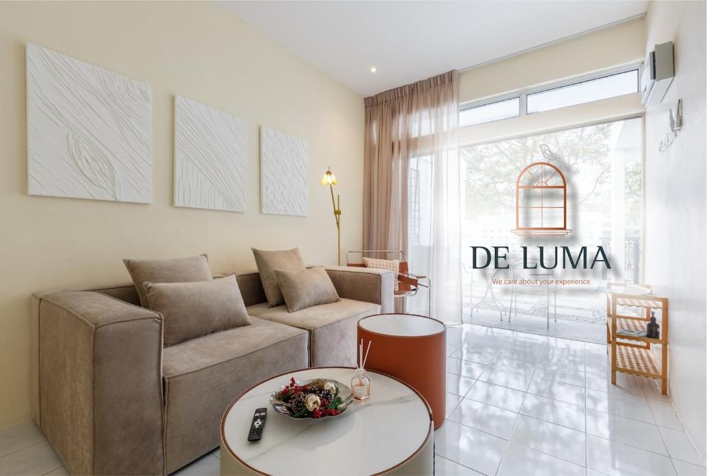 a living room with a couch and a table at De Luma-Cozy 2Bedroom Landed House, Bukit Mertajam in Bukit Mertajam