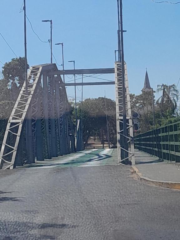 a bridge over a road with a ladder on it at Rancho de Pesca e Pousada Solar in Aquidavana