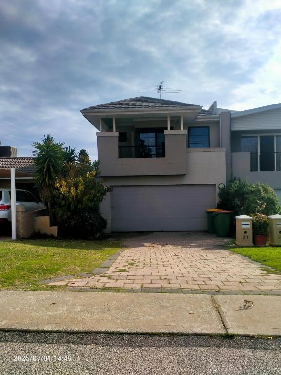 a large white house with a roof at Palmyra Secure holidays Townhouse in Bicton