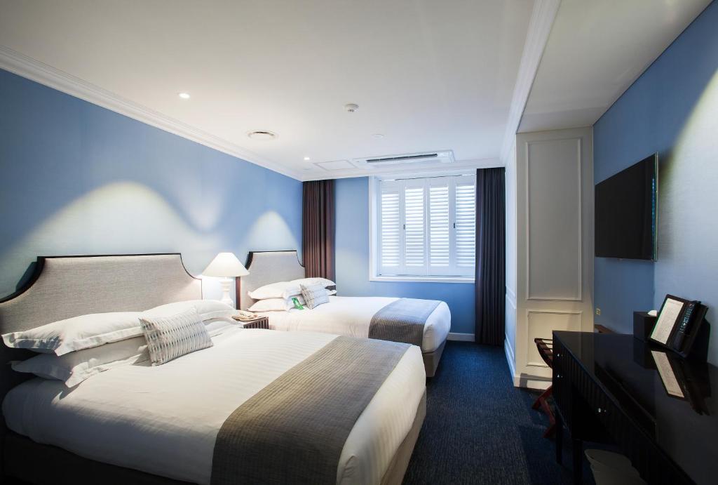 Postel nebo postele na pokoji v ubytování The Grand Hotel Myeongdong
