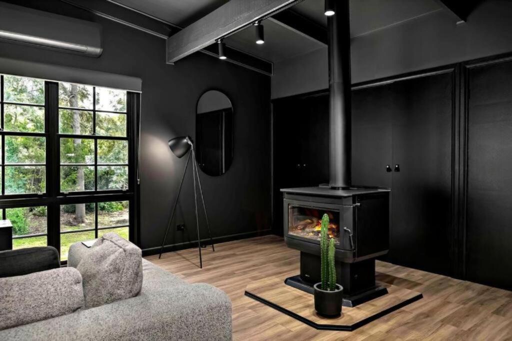 a living room with a fireplace and a couch at Eune House in Broke
