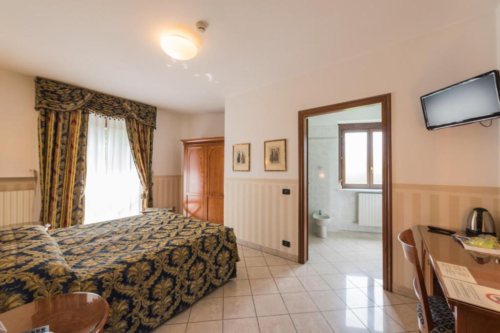 Postel nebo postele na pokoji v ubytování Hotel Belvedere