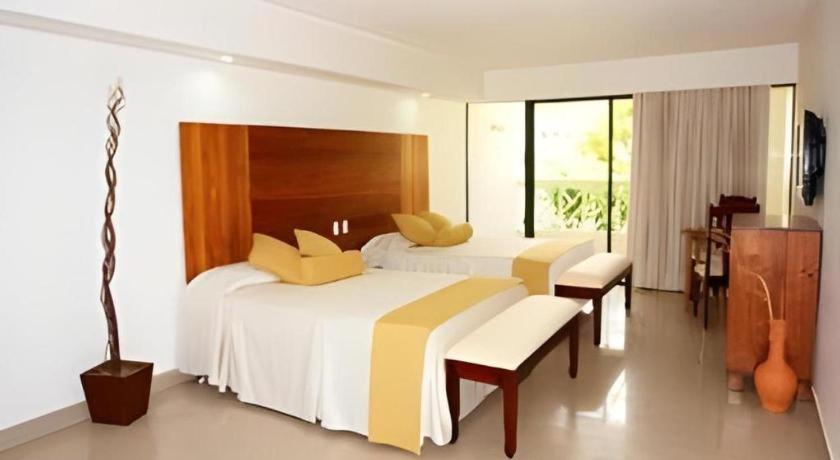 Ένα ή περισσότερα κρεβάτια σε δωμάτιο στο Celuisma Playa Dorada All Inclusive