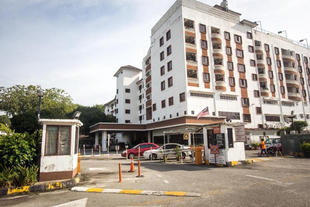 a large white building with a gas station in front of it at Bayu Beach Resort Apartment Seaview Private Beach in Port Dickson