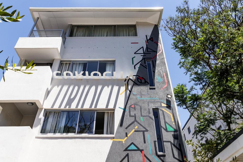 a building with graffiti on the side of it at CURIOCITY Green Point in Cape Town