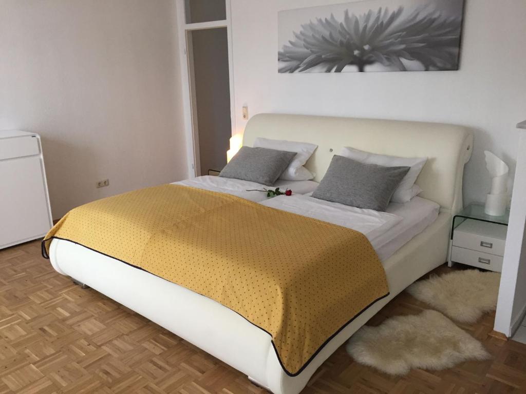 ein Schlafzimmer mit einem großen weißen Bett mit zwei Kissen in der Unterkunft Apartment 'Rheinblick' mit grosser Terrasse in Mainz