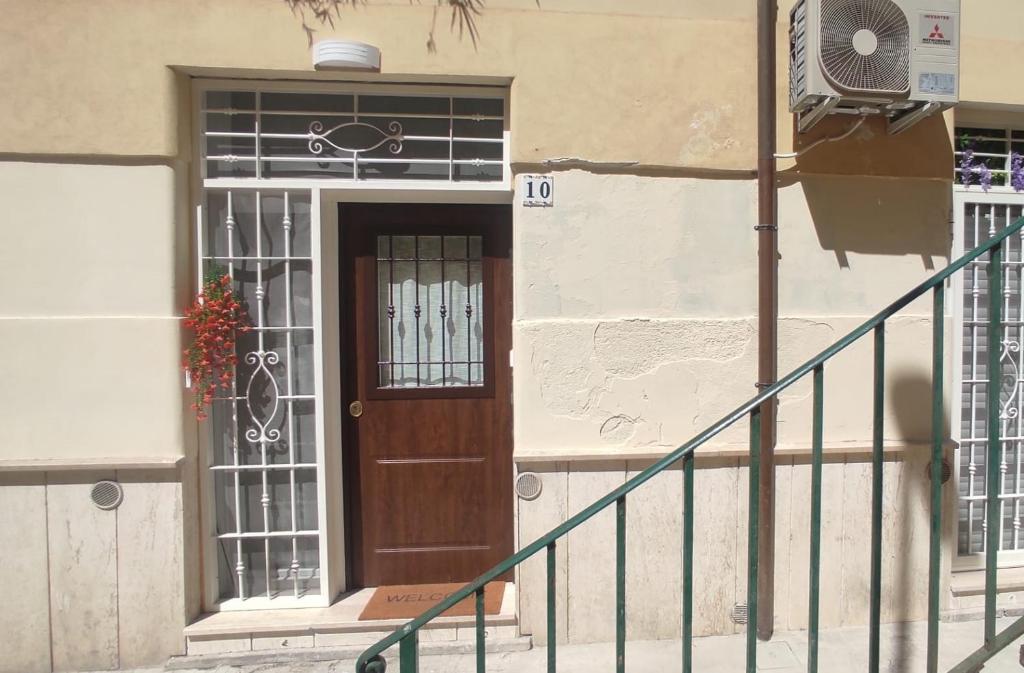 a door of a building with a staircase and a fan at Trilocale indipendente vicino Metro per Colosseo - Domus in Rome in Rome