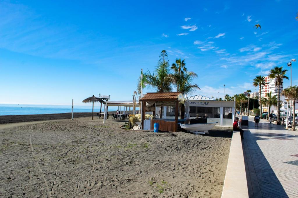 a beach with a building on it next to the ocean at RIO SECO LOFT BEACH- HOME RENt MALAGA in Torre del Mar