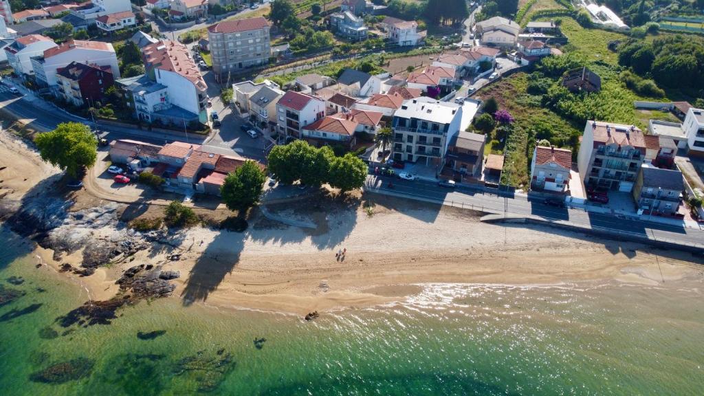 an aerial view of a beach with buildings at La terraza da Braña in Villanueva de Arosa