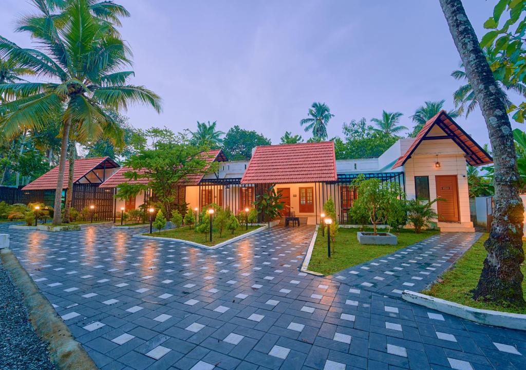 a villa with a courtyard in a resort at Sarang Resort Varkala by VOYE HOMES - Includes Rooms with Private Pool in Varkala
