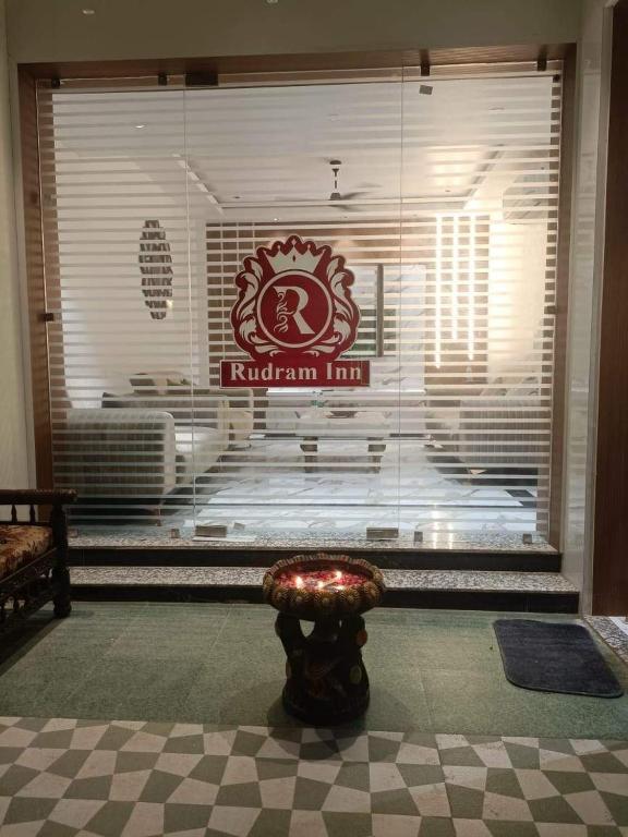 a stool in front of a window with a sign at Rudram Inn in Varanasi