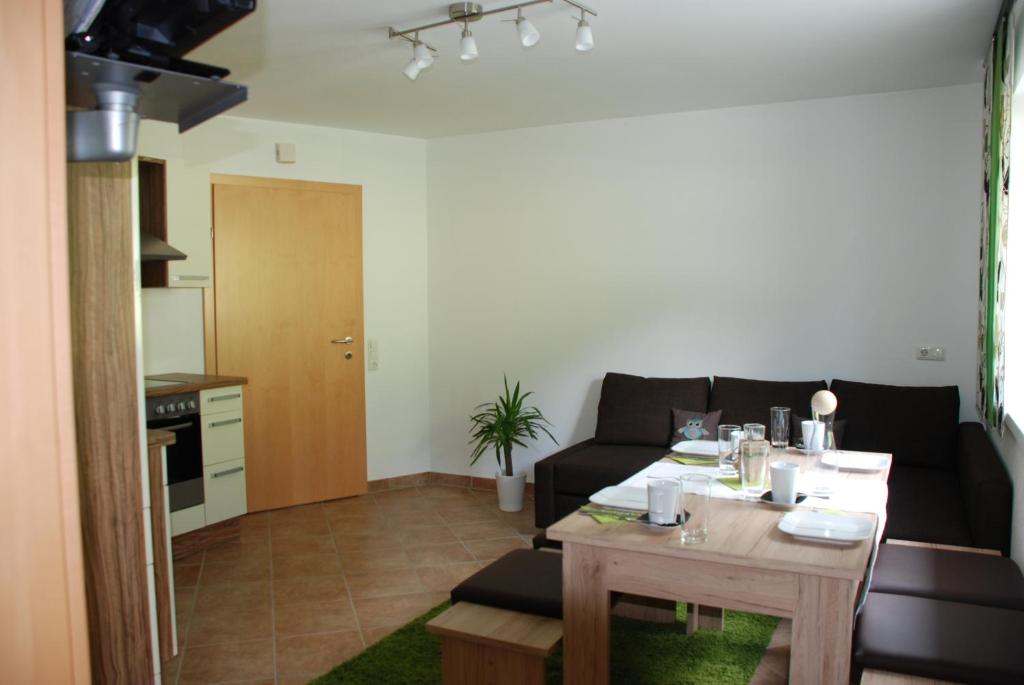 a living room with a couch and a table at Ferienwohnung Kendler in Hüttschlag