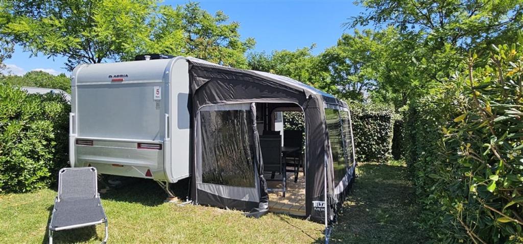 an rv parked in the grass in a yard at Victoria Camping Baška Beach in Baška