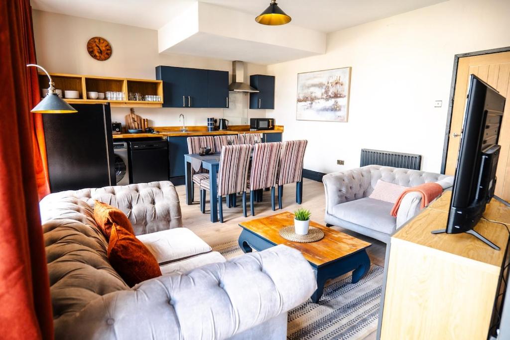 a living room with a couch and a table at The Sandford Park Townhouse 6 Bed Sleeps 12 Entire Apartment in Cheltenham