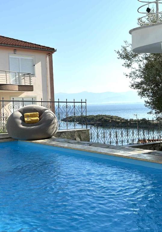 a swimming pool with an inflatable object next to a building at Villa Sea View Complex with pool in Volos