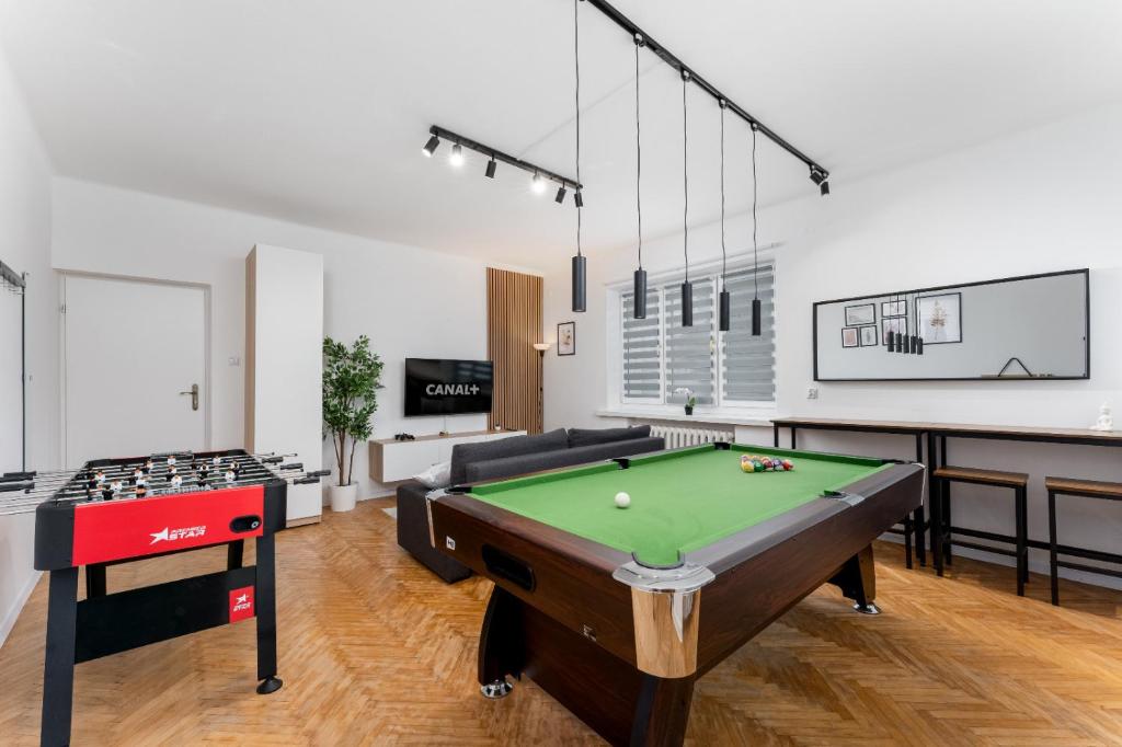 a living room with a pool table and ping pong ball at Zabłocie Comfort House with parking and garden in Kraków
