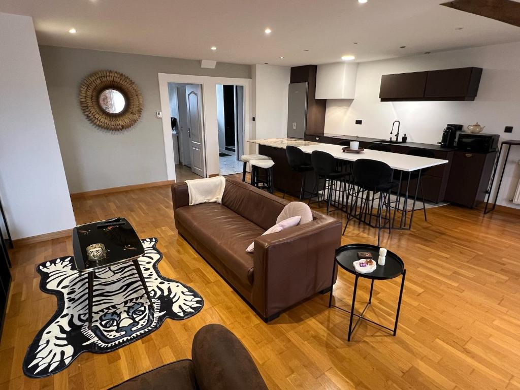 a living room with a couch and a kitchen at Coeur de ville rue de la Paix in Laval