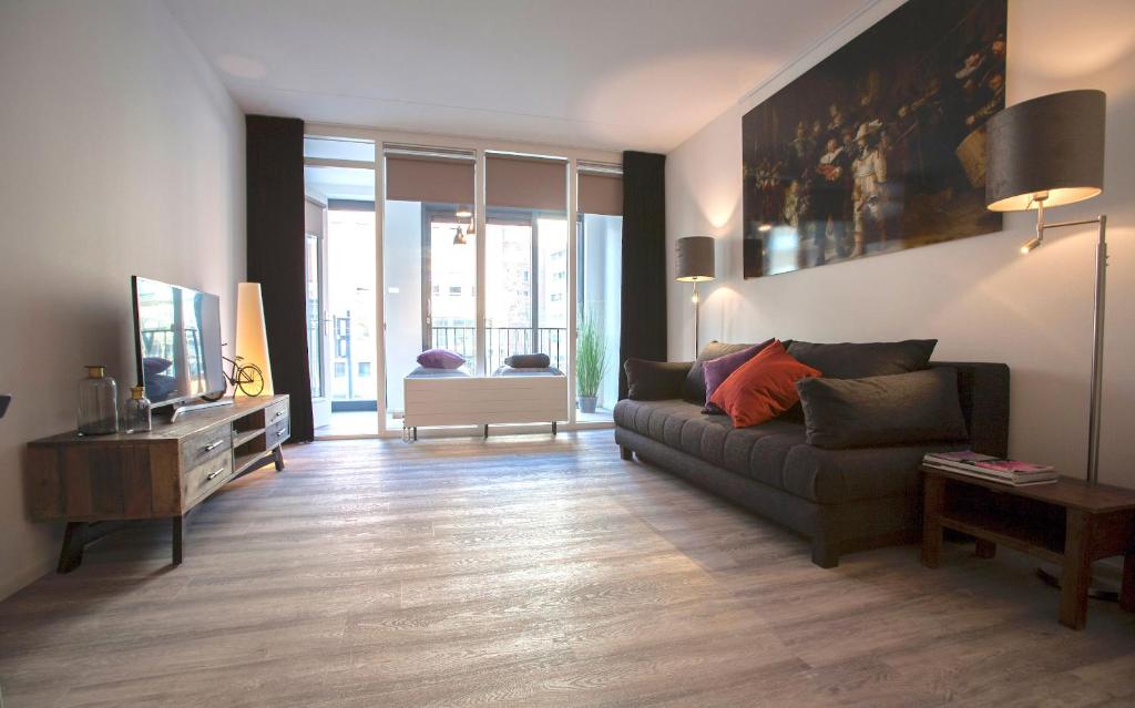 a living room with a couch and a tv at Apartment 4G in Amersfoort