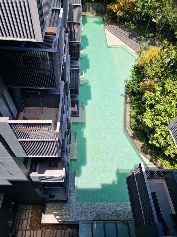 an aerial view of a swimming pool between two buildings at The Deck Condo Patong with mountain view in Patong Beach
