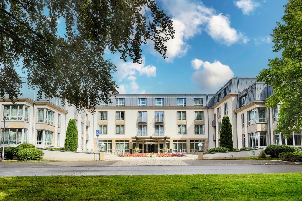 a large white building with a lot of windows at Welcome Parkhotel Bochum in Bochum