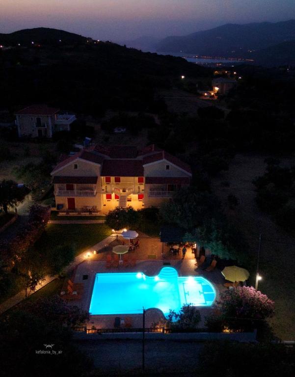 an overhead view of a swimming pool at night at Aria in Lakíthra
