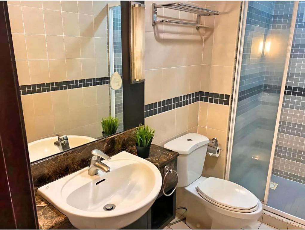 a bathroom with a sink and a toilet and a shower at Seri bukit ceylon residency by An homes in Kuala Lumpur