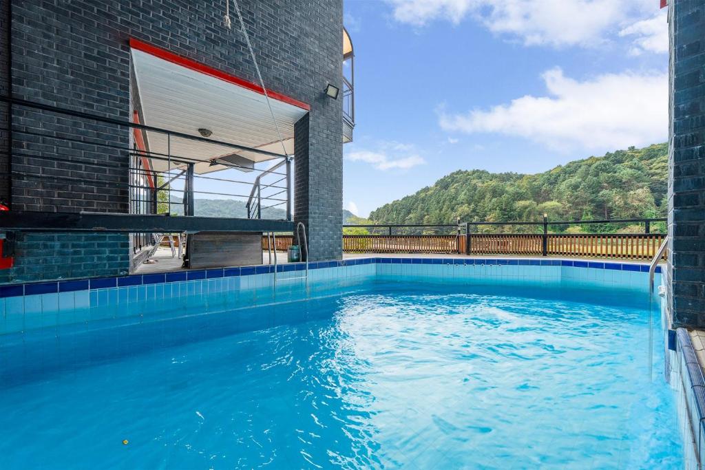 a swimming pool in the middle of a building at Gapyeong River52 Road Pension in Gapyeong
