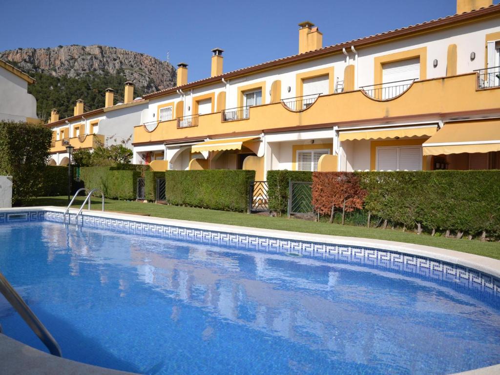 a large swimming pool in front of a building at Casa con Piscina, Cerca de la Playa y del Centro - L'Estartit - ES-323-32 in L'Estartit