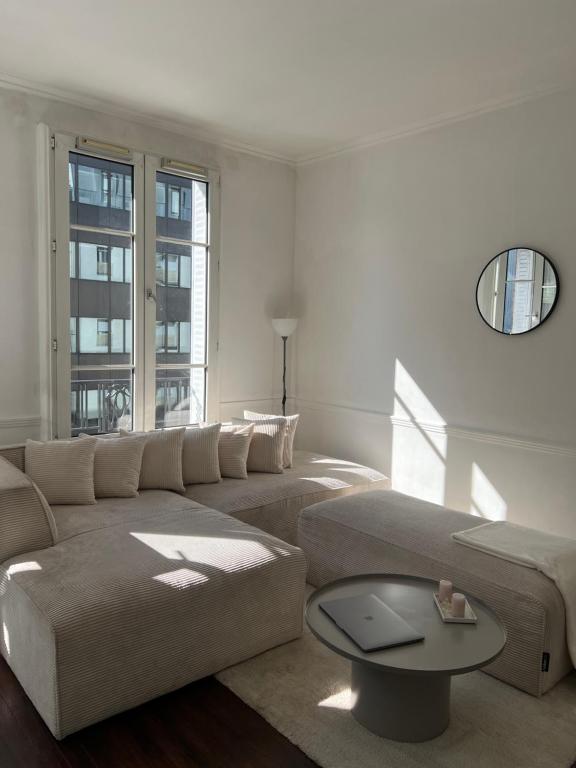 un salon avec un canapé et une table dans l'établissement Appartement Paris Expo Porte de Versailles, à Issy-les-Moulineaux