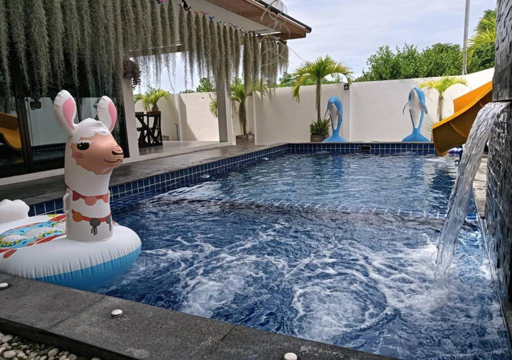 a pool with a inflatable animal in the water at Lemony Pool Villa - Hua Hin in Ban Thap Tai (1)