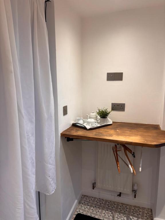 a table in a room with a white wall at Santalijshoteliers private entrance RM 1B in Leicester