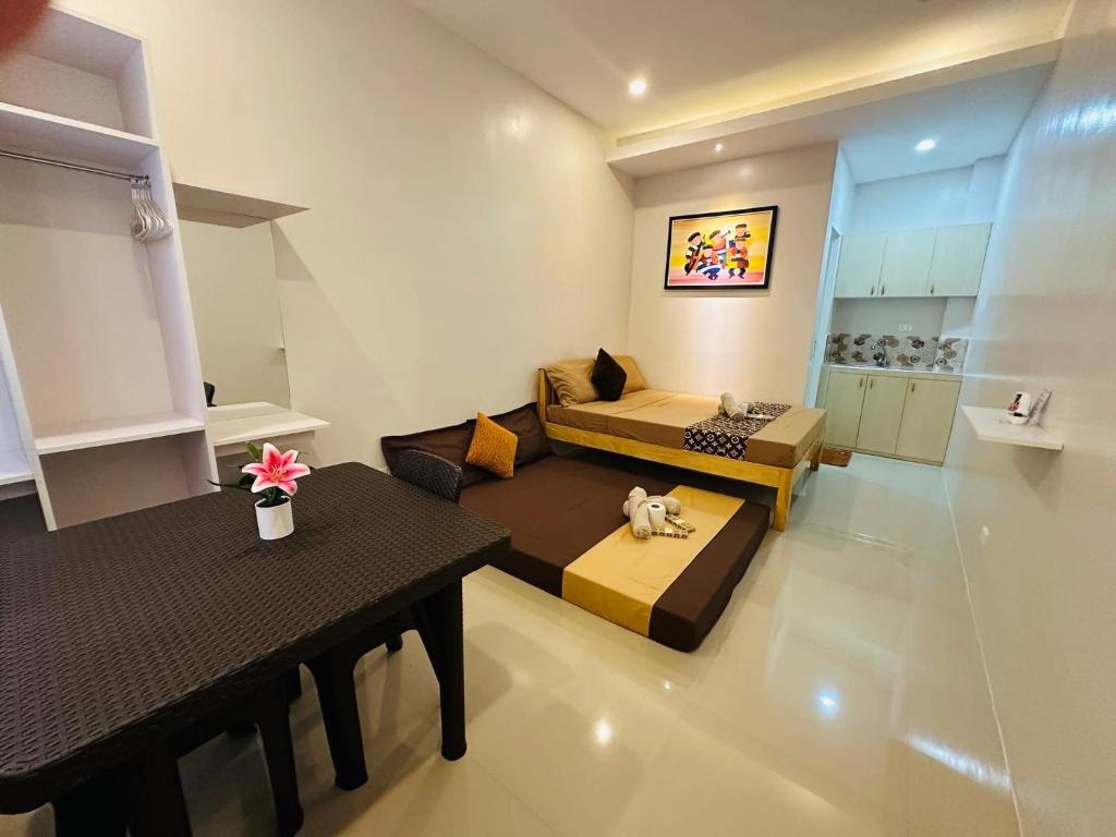 a living room with two beds and a table at ZV Homes in Tagbilaran City