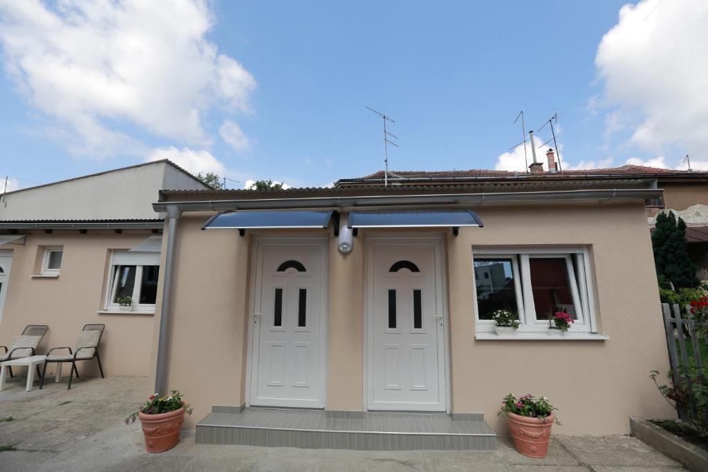 a detached house with a garage with a solarium at Rooms Butković in Zagreb