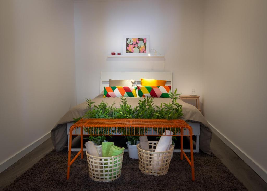 a room with a bed with plants in baskets at Alfama Right Point in Lisbon