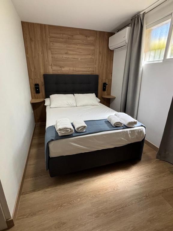 a bedroom with a bed with two towels on it at Habitacion Monteazul in El Casar de Talamanca