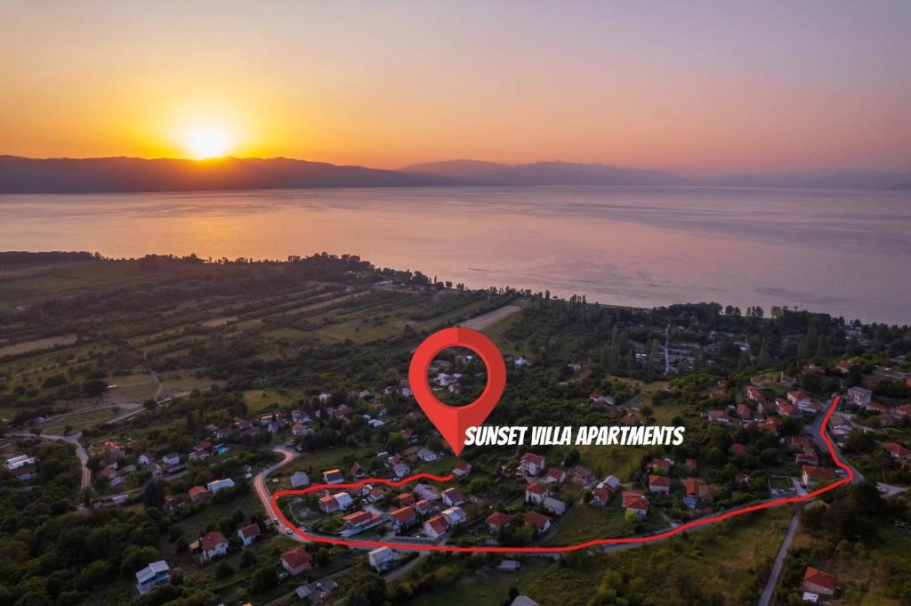 an overhead view of a sunset over a city with a red marker at Sunset Villa Apartments in Ohrid