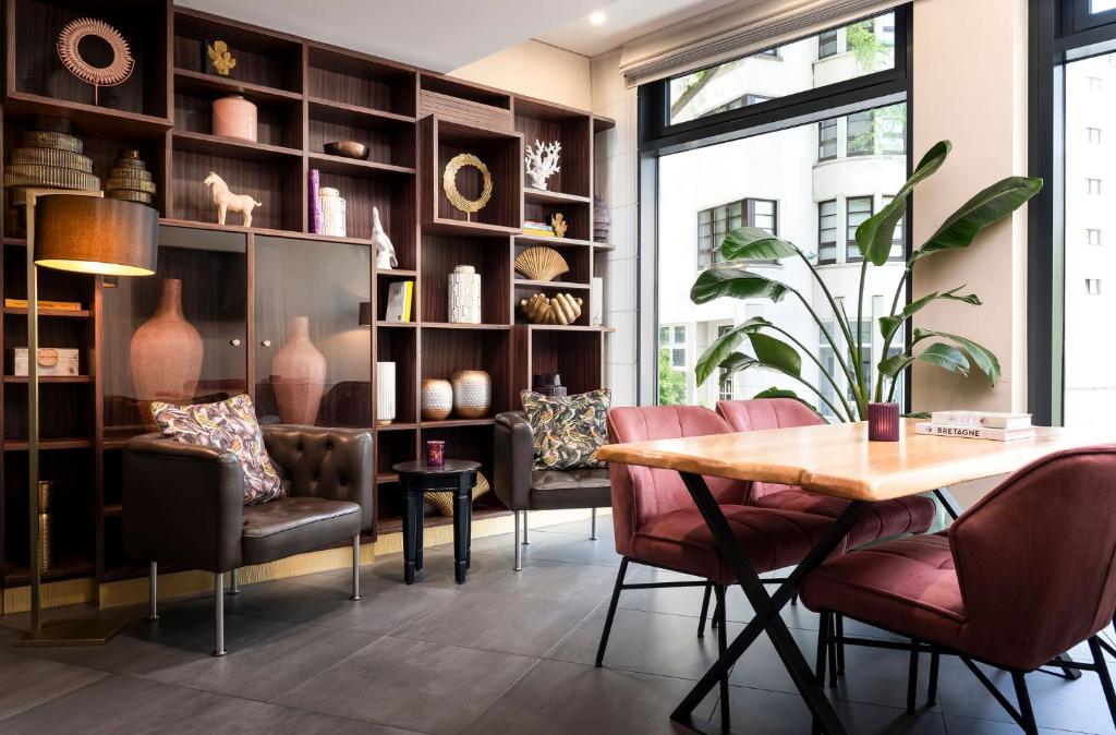 comedor con mesa, sillas y estanterías en Stadthotel am Römerturm, en Colonia