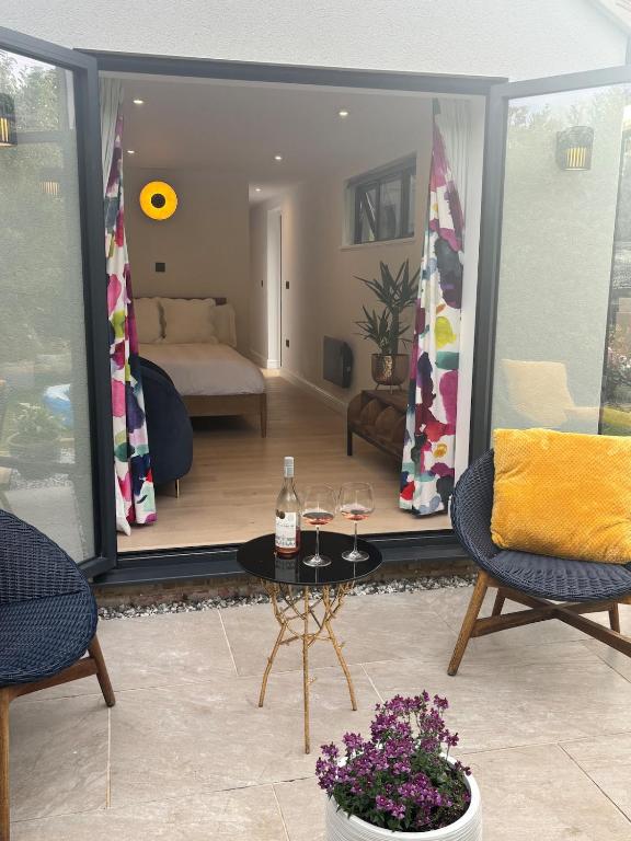 a living room with a view of a bedroom at Cosy Home with beautiful views in Bisley