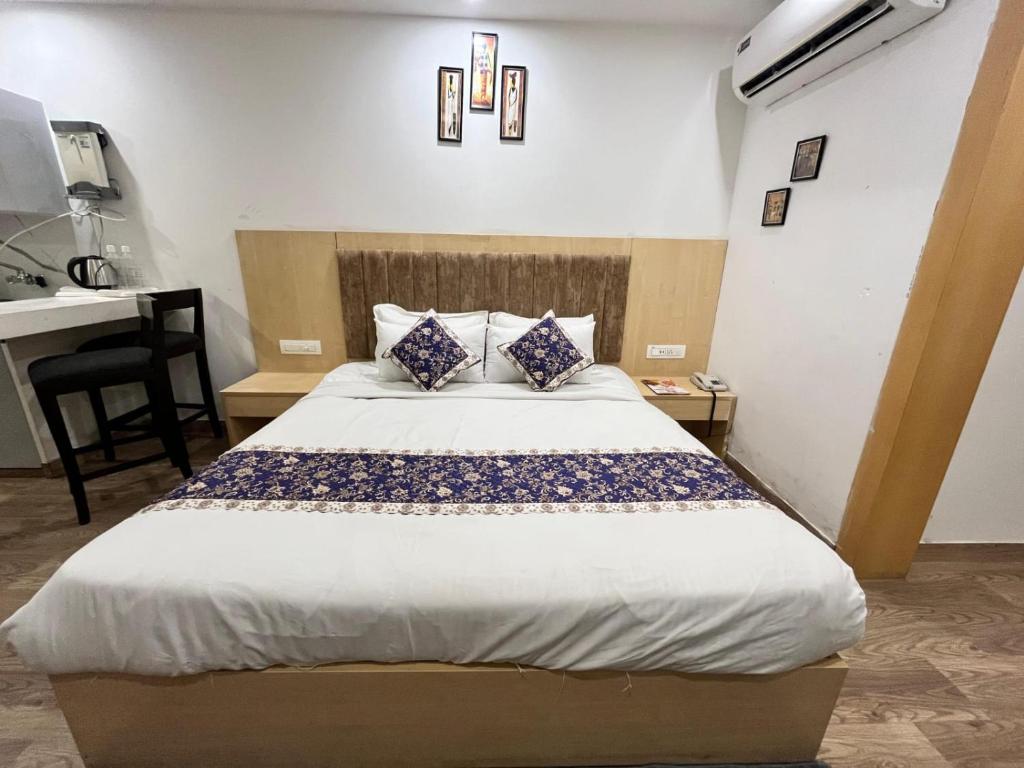 a bed in a room with a desk and a bed sidx sidx sidx at A N Studio Room, The Grand Anukampa in Jaipur