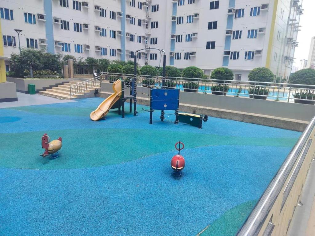 a playground with a slide at Cozy Studio Unit in Quezon City with Private Pool and City Views in Manila
