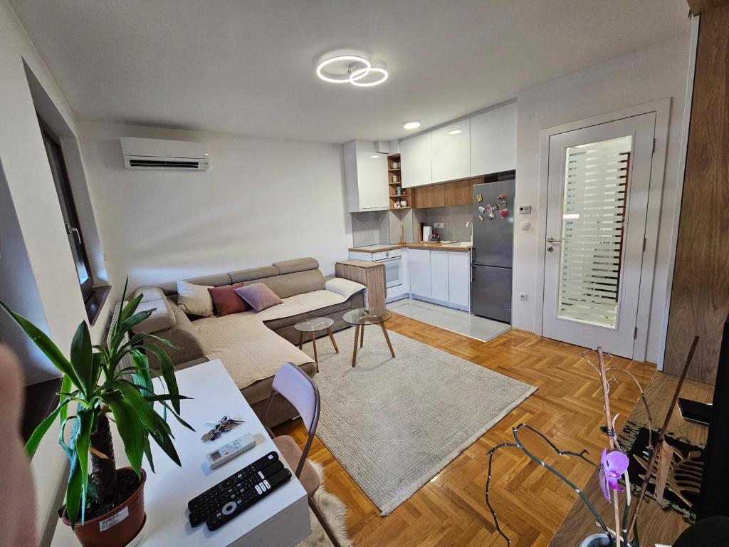a living room with a couch and a table at Urban Nest in Vranješ
