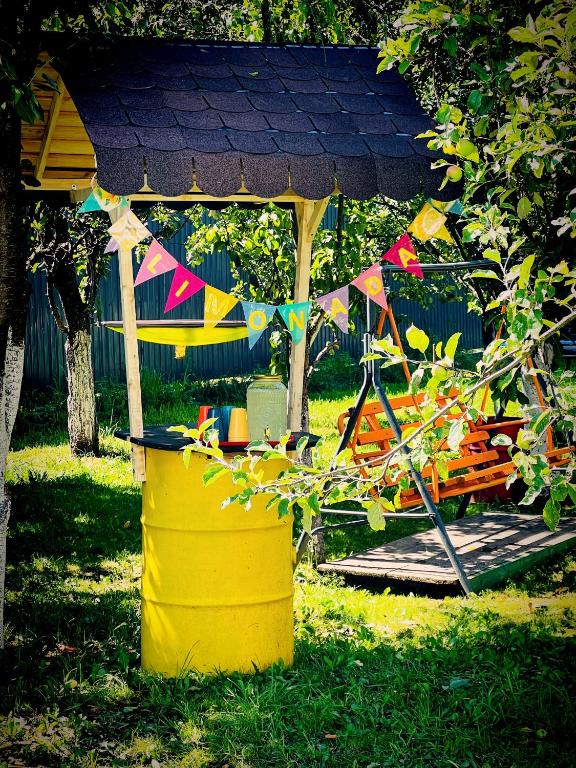 a gazebo with a banner and a bucket at Conacul Perla Bratiei in Cîndeşti