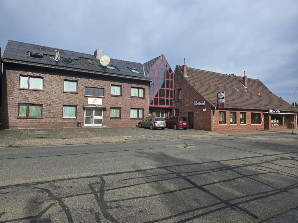 an empty street in front of two brick buildings at Hotel garni Zur Krim in Niederdorla