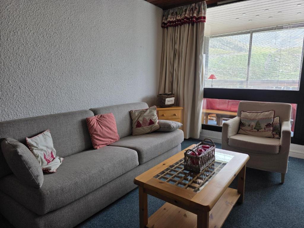a living room with a couch and a coffee table at Le Serac Panoramic Mountain View spacious 40m2 managed by private host in Val Thorens