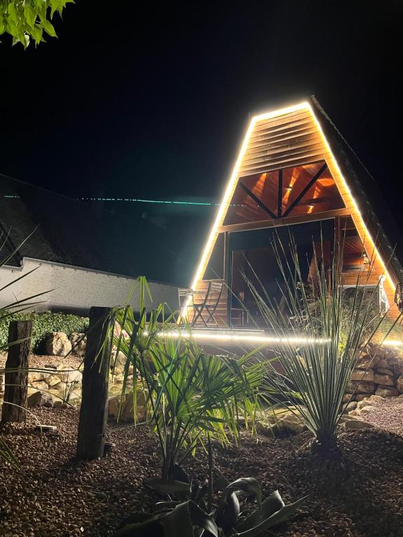 una casa con una luz en la parte delantera por la noche en le moodeng, en Villampuy