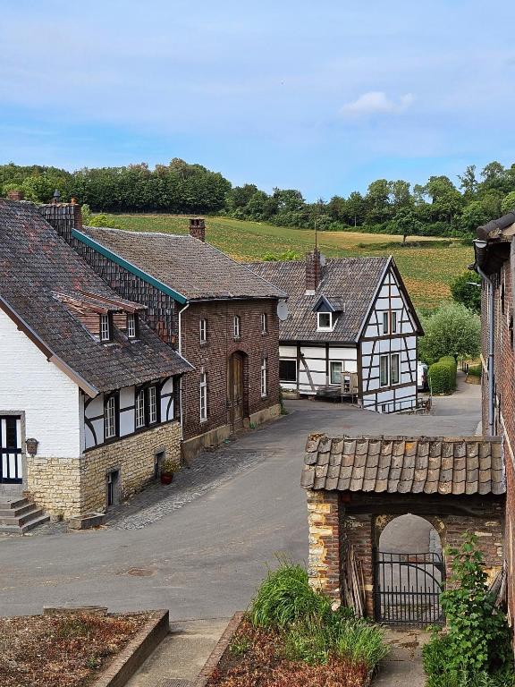 an old village with a stone bridge and buildings at B&B Bij Tante Toos in Lemiers