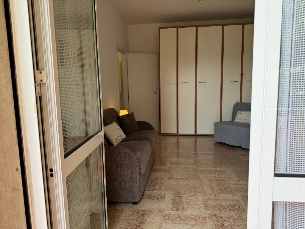 a living room with a couch and a chair at Casa Lina Nolo - M2 - San Raffaele in Milan