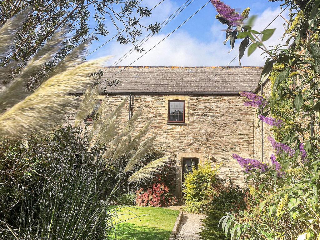an old brick house with a garden in front of it at Sage Cottage in Truro