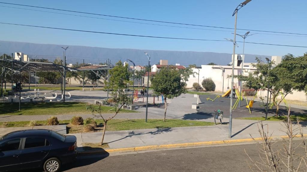 a parking lot with a car parked on a street at Apart de la Plaza in San Fernando del Valle de Catamarca