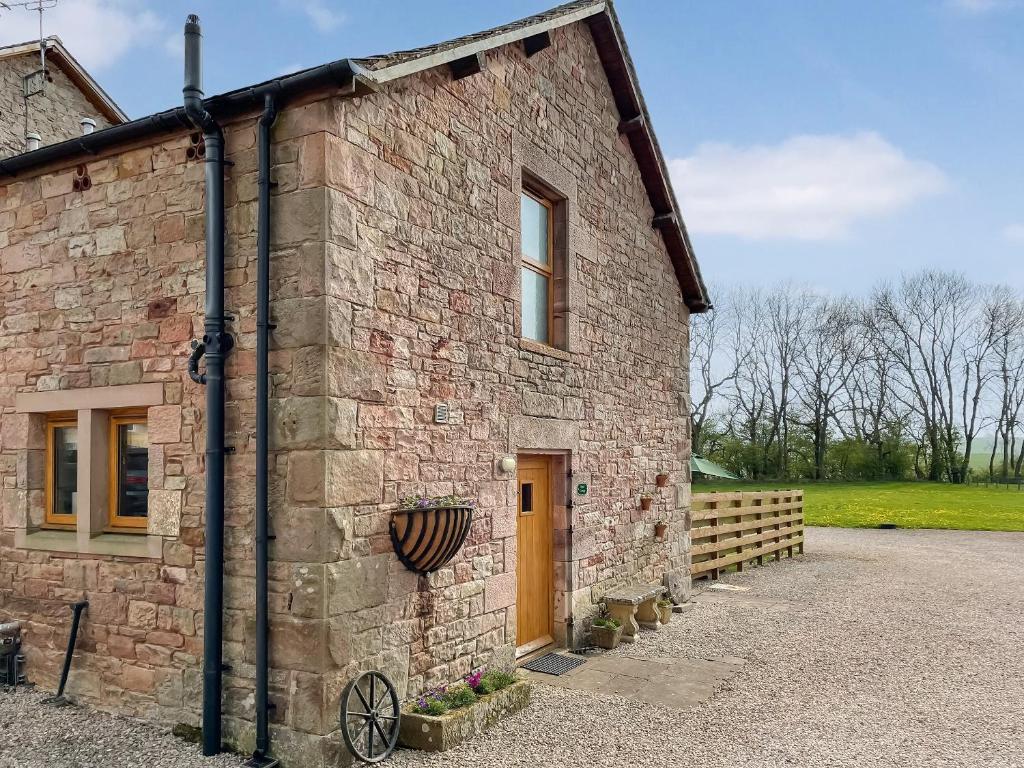 a brick building with a bike parked outside of it at Pippa's Cottage - Uk42332 in Little Blencow